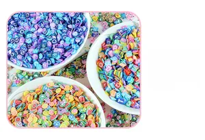 Close-up of vibrant 5mm fruit and letter polymer clay slices for DIY crafts and nail art