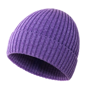 Detailed close-up of dark purple rib-knit beanie showing thick winter fabric texture