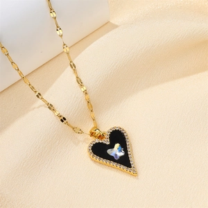 Detail of heart pendant necklace with black enamel, crystal butterfly and rhinestones