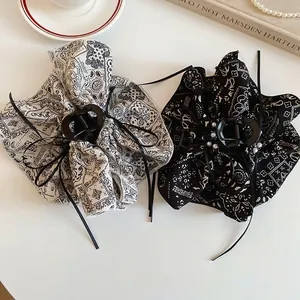 Vintage paisley print hair claws with pearls and ribbon tassels in a two-piece set
