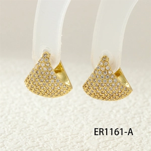 Macro detail of gold-plated hoop earrings with micro-pave white zircon setting