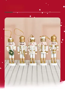 Close-up of five wooden nutcracker ornaments in elegant white and gold festive finishes