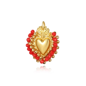 Luxury gold heart pendant with handmade red and gold beads on white background