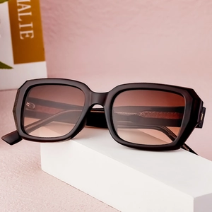 Modern square frame sunglasses with black frames and brown gradient lenses on display