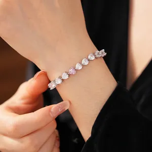 Sparkling zircon heart tennis bracelet in silver with white and pink stones on wrist