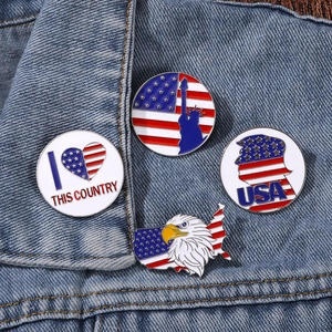 Patriotic USA enamel pins set with Statue of Liberty and American flag on denim jacket