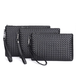 Three-piece set of black woven leather clutch bags with zippers and wrist straps