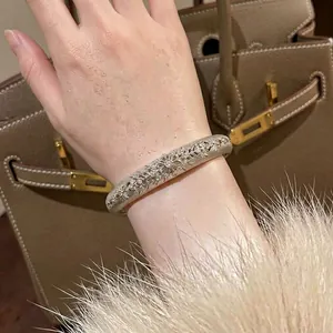 Elegant vintage silver textured open bangle with engraved floral patterns and zircons