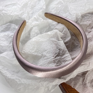 Detailed macro view of the lavender satin headband with a metallic sheen and soft nonslip lining