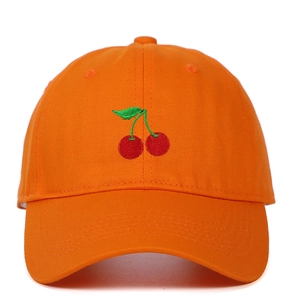 Detail of red cherry embroidery on orange cotton baseball cap with curved brim