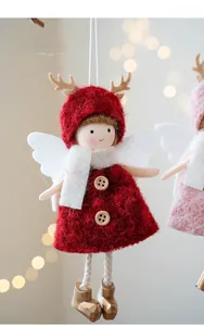 Detail of plush Christmas angel ornament with red knit dress, antlers and soft white wings