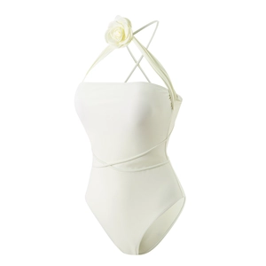 Detail of white one-piece swimsuit featuring a 3D floral accent and crisscross waist straps