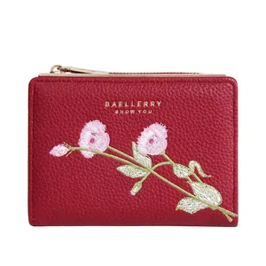 Short red bifold wallet for women featuring elegant floral embroidery and zip closure