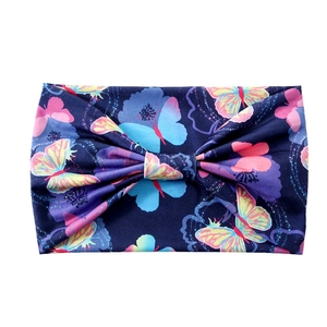 Elastic yoga headband with floral butterfly print and bow knot detail on white background