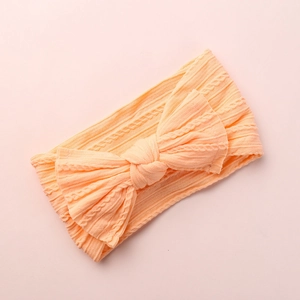 Detail view of baby jacquard headband showing soft ribbed texture and bow design
