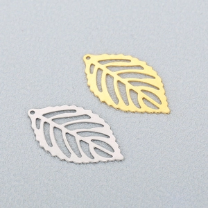 Macro shot of gold and silver hollow leaf metal pendants for DIY jewelry making