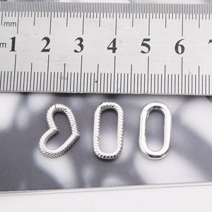 S925 sterling silver heart and oval spring clasps shown with a metric ruler for scale