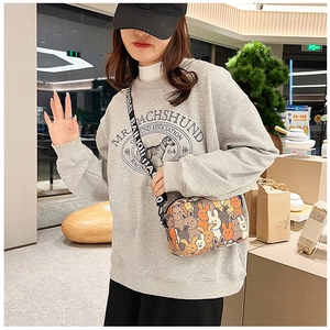 Close-up of cute cartoon rabbit square crossbody bag with lettered woven strap