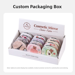 Detail of folding compact mirrors with various illustrations in a white display box