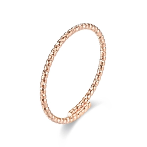 Detail of rose gold twisted texture ring featuring a minimalist hammered finish design