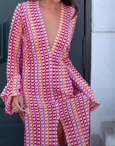 Macro detail of the colorful crochet knit pattern and deep V-neck on this bohemian maxi dress
