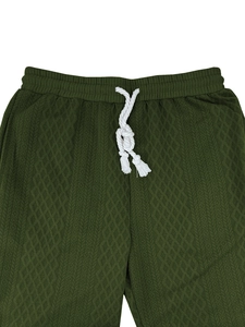Detail of olive green knit joggers featuring diamond texture and white drawstring waist