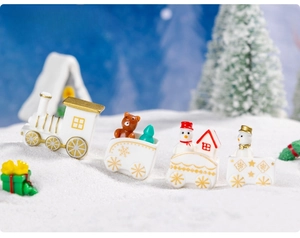 Macro view of Christmas train figurine with resin characters in a snowy winter scene
