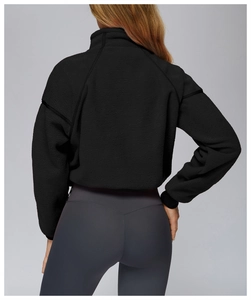 Rear view of black fleece running jacket with stand collar and ribbed cuff details