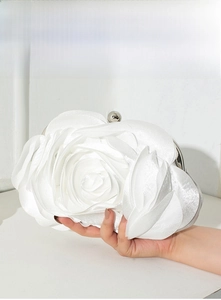 Detailed close-up of white 3D satin rose evening bag with metallic ball clasp