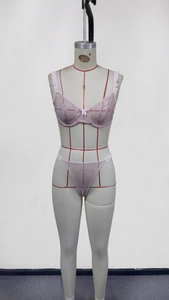 Front detail of pink lace lingerie set with bow accent on professional mannequin