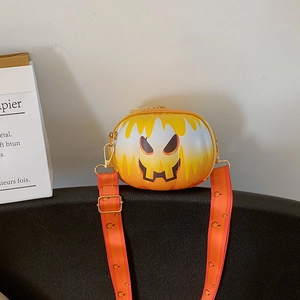 Close-up of Halloween pumpkin crossbody bag with smiley face and striped strap