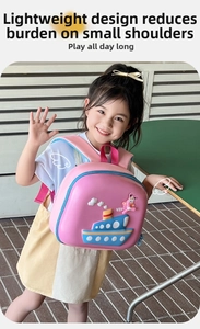 Pink cartoon hardshell backpack for kids with 3D ship design worn by a young girl