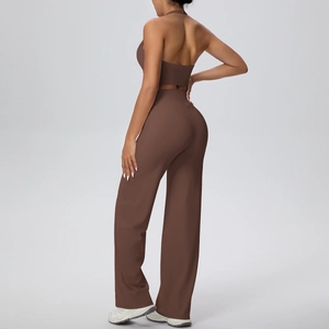 Back view of dark brown halter neck sports top and high waisted wide leg yoga pants