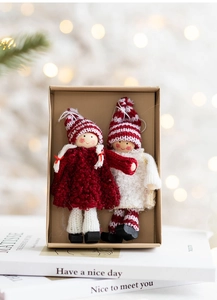 Detail of Christmas wool felt angel dolls in a kraft gift box with festive packaging