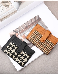 Detail view of houndstooth leather card holder with snap button and card slots