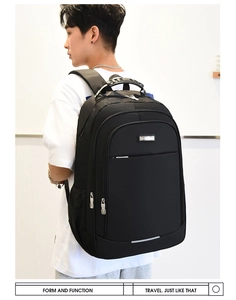 Side view of black business travel backpack with mesh side pocket on male model