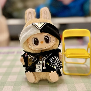 Detail of plush doll outfit with black and white hoodie and tiny metal chain necklace
