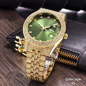 Close-up of golden diamond-set watch with green sunburst dial on a leather texture