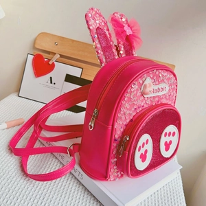 Detail of pink rabbit backpack with sequins, mesh bow ears and paw prints