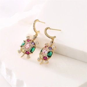 Detailed view of turtle drop earrings with colorful zircons in a gold plated finish