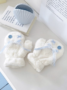 Close-up of white plush mittens featuring lace, light blue ribbon bows and pearl chains