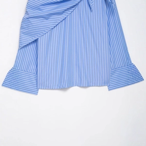 Blue and white vertical striped shirt featuring tiered ruffle hem and buttoned cuffs