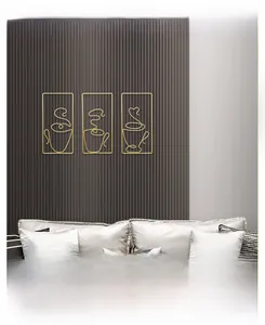 Three-piece gold metal wire coffee cup wall art on modern grey slatted panel
