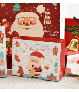 Close-up of festive Christmas paper gift bags with Santa, reindeer and rope handles