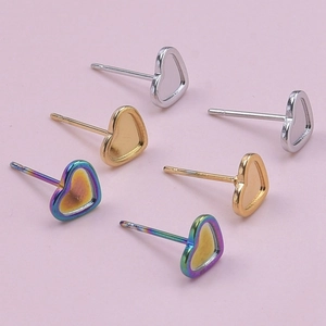 Three pairs of heart-shaped stainless steel earrings in silver, gold, and rainbow finish