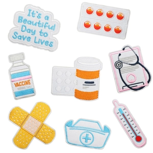 Detailed embroidery texture on medical theme patches including thermometer and medicine icons