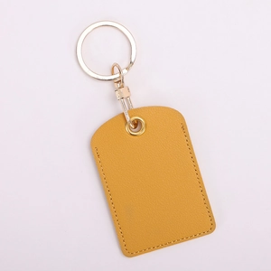 Close-up of yellow PU leather key fob holder with detailed stitching and metal buckle