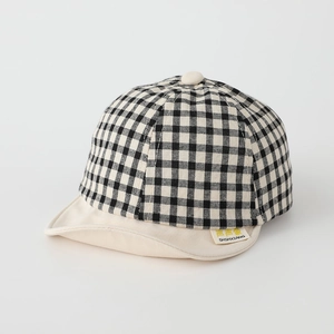 Infant plaid baseball cap in black and white check with beige brim and brand woven label