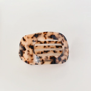 Macro detail of the curved tortoiseshell acetate hair claw clip with strong inner teeth