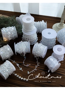 Rolls of iridescent clear plastic bead chains in star and heart shapes for Christmas trees